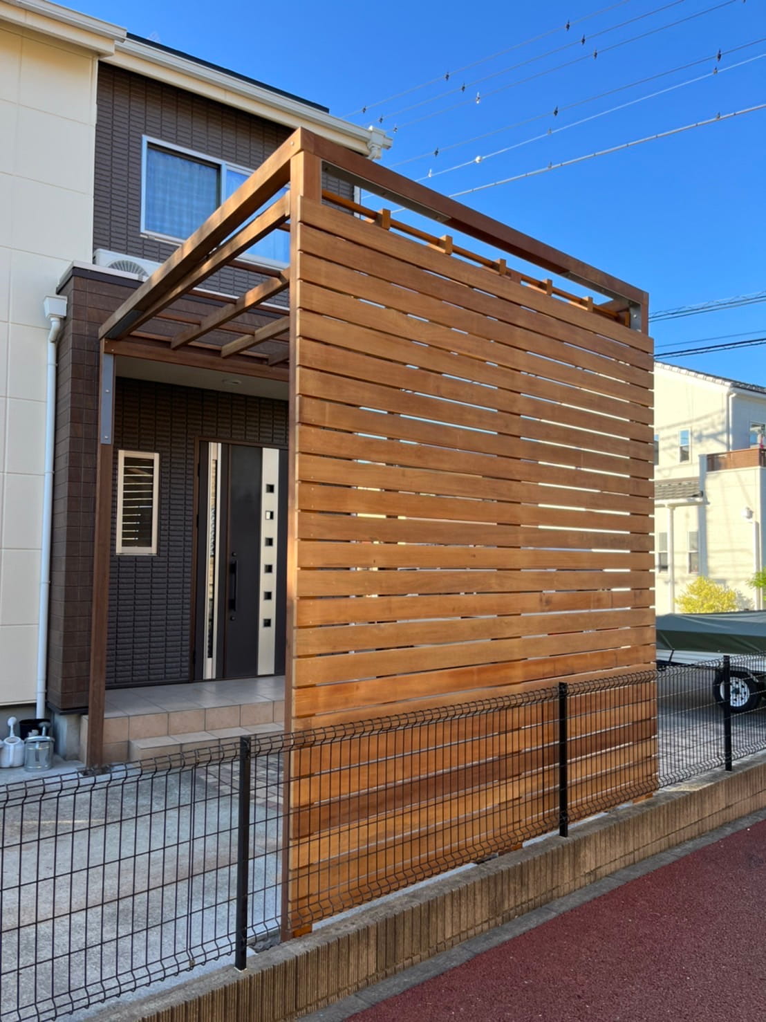 施工後の外構。玄関前に設置された大型の木製目隠しフェンス